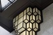 Detail of the adornments of a light located on the main facade, decorating the front door<br />Foto Georges de Kinder  [Ma² - Metzger and Partners Architecture]
