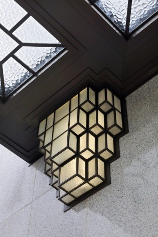 Detail of the adornments of a light located on the main facade, decorating the front door<br />Foto Georges de Kinder  [Ma² - Metzger and Partners Architecture]