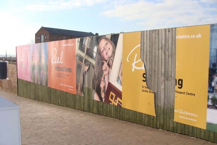 Real shopping. Perto da ponte de pedestres que liga a área central a The Deep, a promoção oficial deteriorada (depredada?) realça o contraste entre a Hull projetada aos turistas e a realidade da cidade<br />foto André Fontan Köhler 