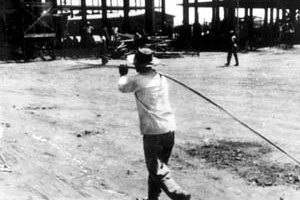 Operário transportando ferragem na construção de Brasília. Foto M. M. Fontenelle [Acervo do Departamento do Patrimônio Histórico e Artístico do DF]